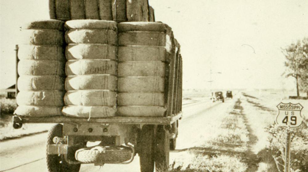 Archival image of truck with cotton bales.