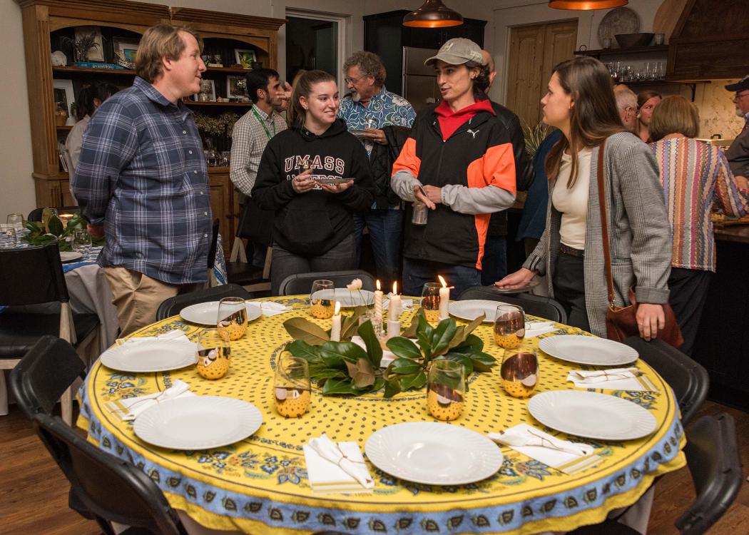 A group gathers around a decorated table.