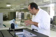 Mississippi State University assistant professor of food safety and microbiology Barakat Mahmoud uses the RS 2400 X-ray machine to rid seafood and produce of harmful bacteria. Here, he places fresh produce carefully wrapped in plastic into the machine. In a matter of a few minutes, the food is irradiated and ready to eat. (Photo by MSU Ag Communications/Karen Templeton)