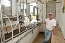Billy Ray Brown stands on the lower level of the milking parlor he built for his Jersey cows. (Photo by Scott Corey)