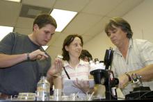 Each fall, scientists from all over the world flock to Mississippi State University to learn the latest in insect-rearing techniques. Blaine Junfin of Kunafin Insectaries and international participants Tara Van Beelen and Neil Naish identify insect pathogens in an MSU lab. (Photo by Kat Lawrence)