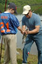 Daryl Jones, an associate Extension professor in Mississippi State University's Forest and Wildlife Research Center and Newton County Middle School student Scott Round look at the catfish Round caught during the Youth Fishing Day at MSU's Coastal Plain Branch Experiment Station in Newton, a branch of the Mississippi Agricultural and Forestry Experiment Station. (Photo by MSU Ag Communications/Susan Collins-Smith)