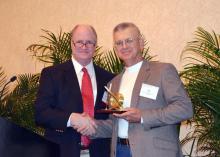 Scott Rowland, South Central regional vice president of the Forest Landowners Association, presents their Extension Forester of the Year award to Don Bales of Purvis, a forest and wildlife management specialist with Mississippi State University's Extension Service. (Submitted Photo)