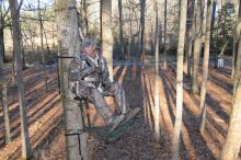 John Louk with the Treestand Manufacturer's Association demonstrates a properly secured safety harness when using a lock-on tree stand. (Photo courtesy of the Treestand Manufacturer's Association)