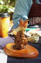 Artist and woodcarver John Houston carved and painted figurines, such as this bird, out of Water Tupelo wood and basswood for sale at the Piney Woods Heritage Festival held Nov. 16 and 17 at Mississippi State University's Crosby Arboretum. (MSU Ag Communications/Susan Collins-Smith)