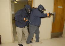 Two law enforcement agents practice clearing a Mississippi State University hallway during an active-shooter response course on March 15, 2013. MSU's Extension Service coordinated the three-day course developed and facilitated by the National Center for Biomedical Research and Training, one of the leading training agencies for U.S. Department of Homeland Security initiatives. (Photo by MSU Ag Communications/Linda Breazeale)