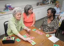 Georgia Murphy (center) observes a friendly card game between Florence Romero (left) and Bobbie Potts at the senior center on May 21, 2013, in Starkville, Miss. (Photo by MSU Ag Communications/Scott Corey)