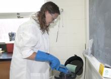 Mississippi State University graduate student Cecilia Langhorne checks the equipment used to freeze Mississippi gopher frog sperm, helping to preserve the genetic diversity of this endangered species. (Photo by MSU Ag Communications/Kat Lawrence)