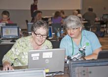 Volunteer and professional robotics instructors spent five days at Mississippi State University increasing their skills in robotics programming. From left, Tiffany Lowrey of the Tishomingo County Career and Technical Center and Evelyn DeAngelo of the MSU Extension Service in Jackson County test their robot with Tim Friez, Carnegie Mellon University software engineer, on Aug. 14, 2013. (Photo by MSU Ag Communications/Kat Lawrence)