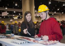 Jessica Graves of Mississippi State University's Animal and Dairy Sciences Department explains the different cuts of beef and pork to David Eisman, an eighth-grader at Bayou View Middle School, during Mississippi's first Pathways2Possibilities career expo in Biloxi Nov. 13. The event introduced 19 different career paths, including agriculture, to eighth-graders from 27 public, private and home schools in the six coastal counties. (Photo by MSU Ag Communications/Kat Lawrence)