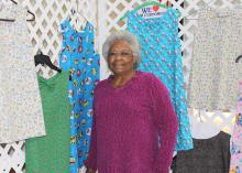 Helen Coleman, president of the Bolivar County Mississippi Homemaker Volunteers, gathers dresses created by her club to send to children in need for the MHV International Project. (Photo by MSU Ag Communications/Keri Collins Lewis)
