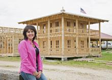 Jo Lynn Mitchell stops near the construction of Tiny Town, an addition to the agritourism venture at Mitchell Farms in Collins, Miss., on April 17, 2014. (Photo by MSU Ag Communications/Kat Lawrence)