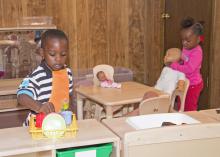 The children of Destiny's Day Care in Louisville, Mississippi, enjoy new classroom equipment in their temporary location on May 16, 2014, after the original site was destroyed by a tornado. With assistance from many, including MSU early care and education programs, the center reopened seven days after the storm. (Photo by MSU School of Human Sciences/Alicia Barnes)