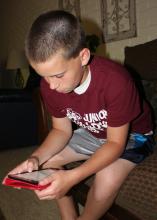 David Coblentz, 12, uses a search engine on an iPad mini. Parents should take some practical steps to help ensure their children are protected as they use Internet-connected devices to socialize or do homework. (Photo by MSU Communications/Bonnie Coblentz)