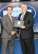 Ryan Akers, an assistant Extension professor in the Mississippi State University School of Human Sciences, left, receives Champions of Change recognition from Federal Emergency Management Agency administrator Craig Fugate at recent ceremonies in Washington, D.C. Additionally, the Mississippi Youth Preparedness Initiative, which is coordinated by Akers, won the national FEMA Individual and Community Preparedness Award for Most Outstanding Youth Preparedness program. (Submitted photo)