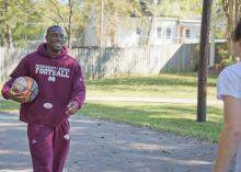 Mississippi State University senior football player Robert Johnson plays basketball with one of the residents of Sally Kate Winters Family Services Emergency Shelter Program. (Photo by David Ammon/ College of Agriculture and Life Sciences)