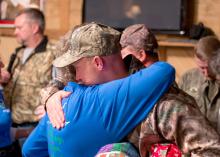 Wanda Hall of Mt. Olive hugs Paul O'Neill of Memphis, Tennessee, a veteran of the U.S. Army's 3rd Stryker Brigade on Dec. 12, 2014, in appreciation for his military service. O'Neill is one of nine soldiers who participated in the Hot Coffee Hunts for Heroes and received quilts from the Mississippi Homemaker Volunteers of Covington County. (Photo by Robert Lewis)