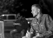 Jack Walker of Hattiesburg sits by the campfire on Dec. 12, 2014 at the Hot Coffee Hunts for Heroes held for wounded veterans. (Photo by Robert Lewis)