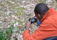 Kymari Young, a Mississippi State University Extension Service 4-H member from Simpson County, takes a close-up photo of daffodils March 8, 2015, in Natchez during a four-day photo safari. Eleven 4-H'ers from across the state visited historic sites from Leland to Natchez to improve their photography skills. (Photo by MSU Ag Communications/Susan Collins-Smith)