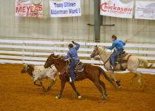 Jake Fulgham, the header, and Ty Edmondson, the heeler, take part in a team roping event at the 4-H Spring Rodeo Classic in April 2016 at the Chickasaw County Agri-Center.  (Photo by MSU Extension Service/Susan Fulgham)