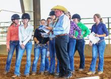 Tom McBeath of Union, Mississippi, explains a riding pattern he will judge to a group of young women. McBeath, a long-time volunteer with the Mississippi 4-H Program, is the American Youth Horse Council Adult Leader of the Year. (Photo by Jeff Homan)