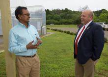Raja Reddy, a research professor with the Mississippi Agricultural and Forestry Experiment Station, left, shows American Farm Bureau Federation President Zippy Duvall the Soil-Plant-Atmosphere-Research Facility at the R.R. Foil Plant Science Research Center in Starkville, Mississippi, on June 21, 2017. (Photo by MSU Extension Service/Kevin Hudson)