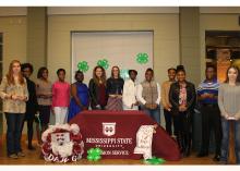 A group of teenagers pose for a photo celebrating their induction as 4-H Leadership team members.