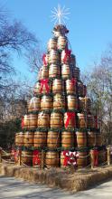 Nine layers of stacked and decorated whisky barrels make a Christmas tree shape.