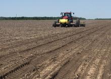 Clear skies have been rare sights as Mississippi farmers started planting their 2016 crops. This soybean planter is establishing a variety trial in a Sunflower County field on May 10, 2016. (MSU Extension Service photo/Greg Flint)