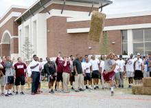 Junior Nick James of Long Beach gives his best effort during a hay bale distance-throwing contest at the fifth annual Beefing Up the Bulldogs event at Mississippi State University on Aug. 16, 2015. Event sponsors included the Mississippi Cattlemen’s Association, the Mississippi Beef Council, First South Farm Credit and the MSU Department of Animal and Dairy Sciences. (Photo by MSU Ag Communications/Kat Lawrence)