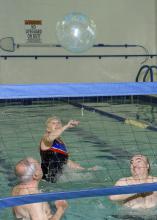 Adults enjoy a friendly game of water volleyball as they aim for at least 150 minutes of moderate exercise each week. (MSU Extension Service file photo/Kevin Hudson)