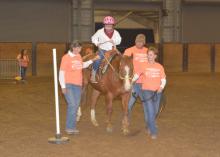 Ji Ji Pridmore leads an “equine therapist” named Fred around a pole, while Kylie Grace Robertson of Hamilton communicates her commands with the reins. Side walkers Fay Ray and Lantz Stewart assist on April 19, 2016, at the second annual Therapeutic Riding Expo at the Mississippi Horse Park, located south of the Mississippi State University campus. (Photo by MSU Extension Service/Linda Breazeale)