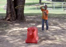 C.J. Martin, 8, practices his newly learned roping skills during the Adams County Farm Camp near Natchez, Mississippi, on July 6, 2016. (Photo by MSU Extension Service/Linda Breazeale)