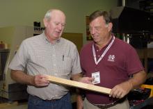Mississippi Representative Ken Morgan of Marion County, left, examines a wood product held by Dan Seale, a professor of sustainable bioproducts at the R.T. Clapp Forest Products Lab at Mississippi State University. Morgan and other members of Senate and House agricultural committees visited MSU on Oct. 18 and 19, 2016. (Photo by MSU Extension Service/Kevin Hudson)