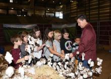 Mississippi State University Extension Service agent Dennis Reginelli explains cotton to students visiting FARMtastic in 2015. This year’s agricultural event will take place Nov. 14-18 at the Mississippi Horse Park near Starkville, Mississippi. (Photo by MSU Extension Service/Kat Lawrence)
