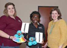 Mississippi State University Extension Service agents Jennifer Williams of Webster County, left, and Monet Kees of Pearl River County hold Dash & Dot interactive robots used by young 4-H’ers to learn STEM concepts. At right is Mariah Smith, an assistant Extension professor with the Center for Technology Outreach. Smith developed a curriculum last year that uses the robots along with mini iPads, all of which were funded through a $14,000 grant from the Verizon Foundation. (Photo by MSU Extension Service/Kat 