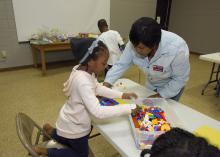 Sandra Jackson, an agent of the Mississippi State University Extension Service in Winston County, helps 6-year-old Akilah Goss assemble a Lego maze March 16, 2017. Jackson was the first agent to teach the 4-H Lego Engineering Club curriculum, which is a STEM program geared toward 4-H’ers aged 5 to 7. (Photo by MSU Extension/Kevin Hudson)