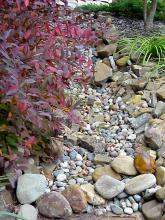 A dry creek bed can flow as needed and is one of the hottest trends in Mississipp.