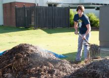 Ted Benge, a landscape architecture student from Nashville, turns a steaming compost pile at Mississippi State University as part of a project begun last spring. (Photo by MSU Ag Communications/Kat Lawrence)