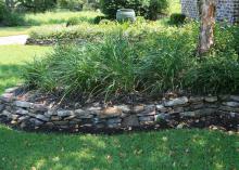 Using stone or brick to contain a raised bed makes a decorative border that keeps the landscape tidy. (Photo by MSU Ag Communications/Gary Bachman)