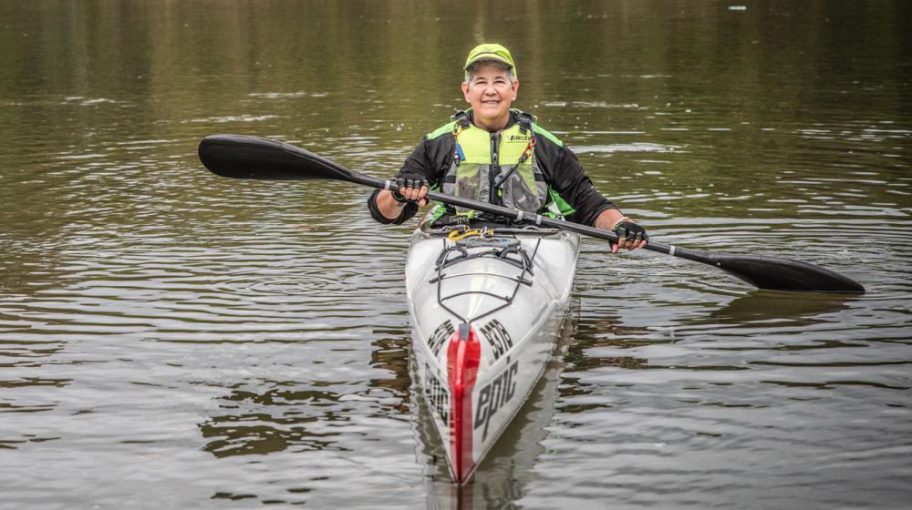 A woman kayaking on the water.