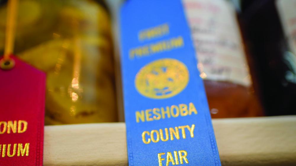 a red and blue ribbon from the Neshoba County Fair