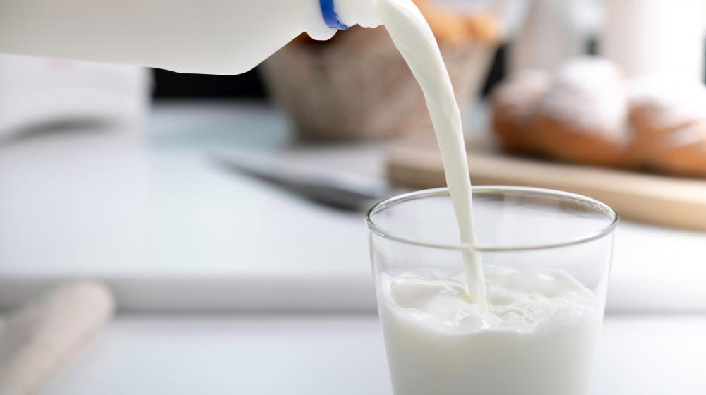 Milk is poured from a jug into a glass.