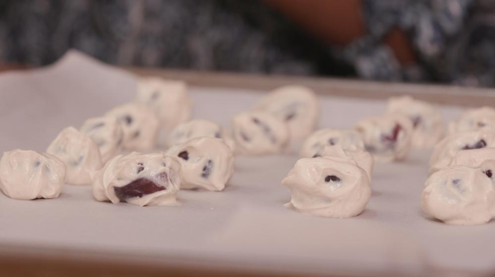 Frozen yogurt-dipped grapes sit on a baking sheet.