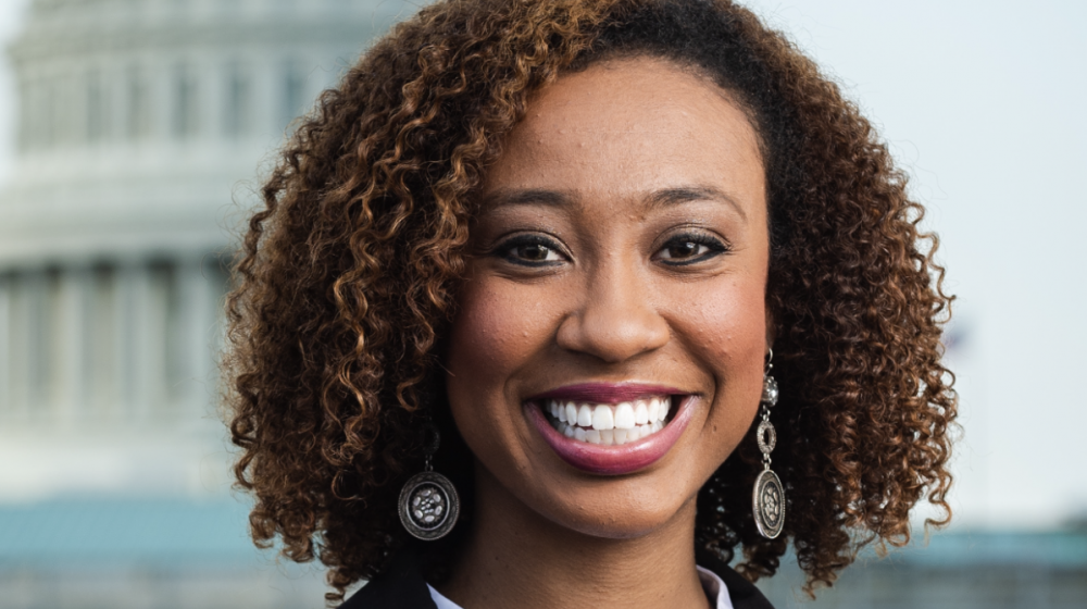 Headshot of a young black woman in business attire.