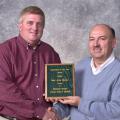 Mississippi State University Extension Service soybean specialist Alan Blaine, left, was presented with the Mississippi Society of        			Agronomy's Agronomist of the Year award by the organization's president David Roberts.