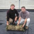 Phillip Jennings Turf Farm in Soperton, Ga., has acquired the rights to commercialize soilless sod produced with technology developed and patented by Mississippi State University. Phillip Jennings, left, the company's president and owner, and Mike Fulghum hold a completed section of soilless sod in a greenhouse ready to receive a new crop.