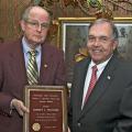 MSU Vice President for Agriculture, Forestry and Veterinary Medicine Vance Watson, right, presents a plaque to Robert L. Williams recognizing the scholarship honoring the agricultural economist. (Photo by Bob Ratliff, MSU Office of Ag Communications)