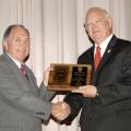 Mississippi State University's Vice President for the Division of Agriculture, Forestry and Veterinary Medicine Vance Watson, left, presents Dr. Lester Spell with the Vice President's Pegasus Award at "All College Day," held recently at MSU's College of Veterinary Medicine. Spell studied pre-veterinary medicine at MSU before going to Auburn to earn a doctorate of veterinary medicine in 1968. He has served as Mississippi's Commissioner of Agriculture and Commerce since 1996. (Photo by Tom Thompson/MSU Ag Com