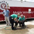 Fourth-year Mississippi State University College of Veterinary Medicine student Katie Ebers and faculty member Dr. Phil Bushby provided services to security dogs working at the National Governors' Conference in Biloxi. Here they are giving a bath to a dog with irritated skin. (Photo by MSU College of Veterinary Medicine/Dr. Carla Huston)